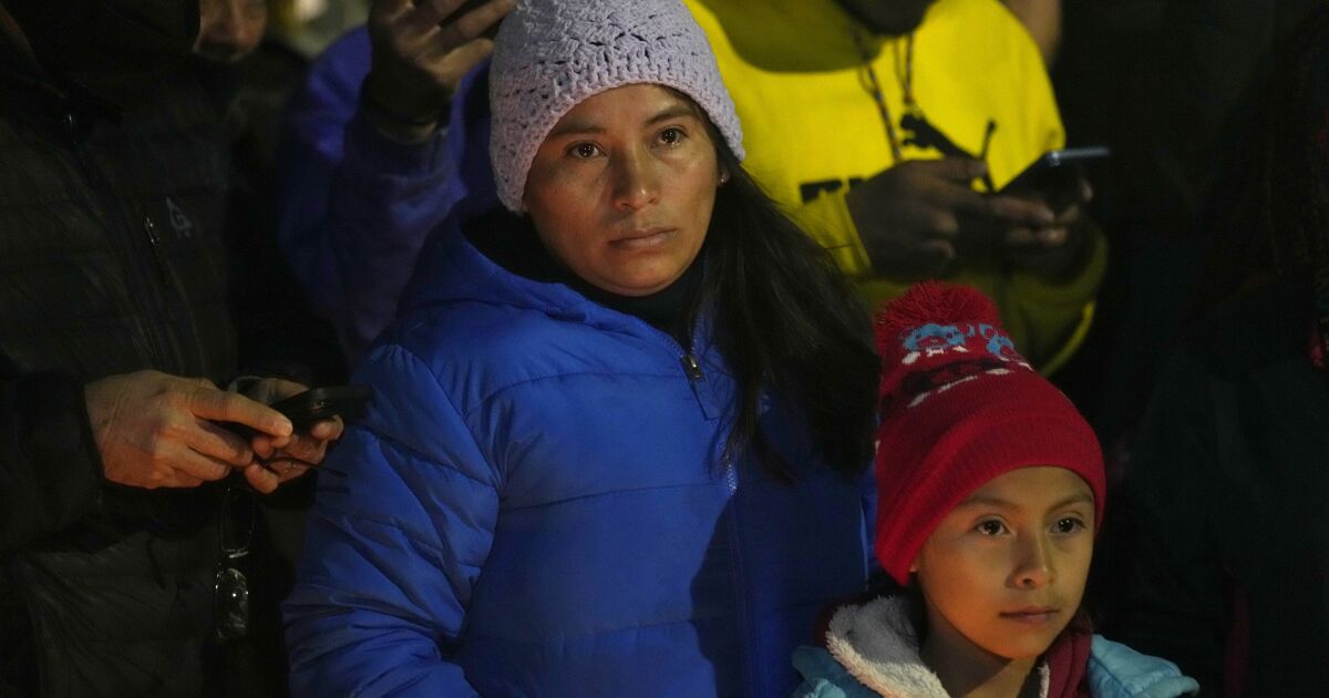 Migrants attend a vigil for the victims of a fire at an immigration detention center that killed dozens, in Ciudad Juarez, Mexico, Tuesday, March 28, 2023. According to Mexican President Andres Manuel Lopez Obrador, migrants fearing deportation set mattresses ablaze at the center, starting the fire. (AP Photo/Fernando Llano)