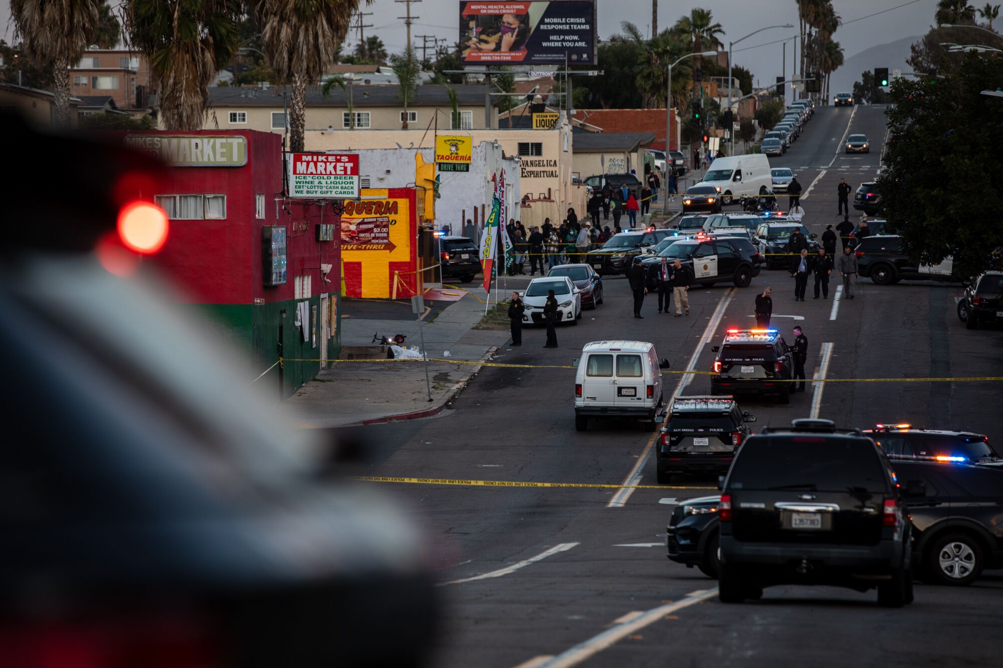 Police are seen outside Mike’s Market