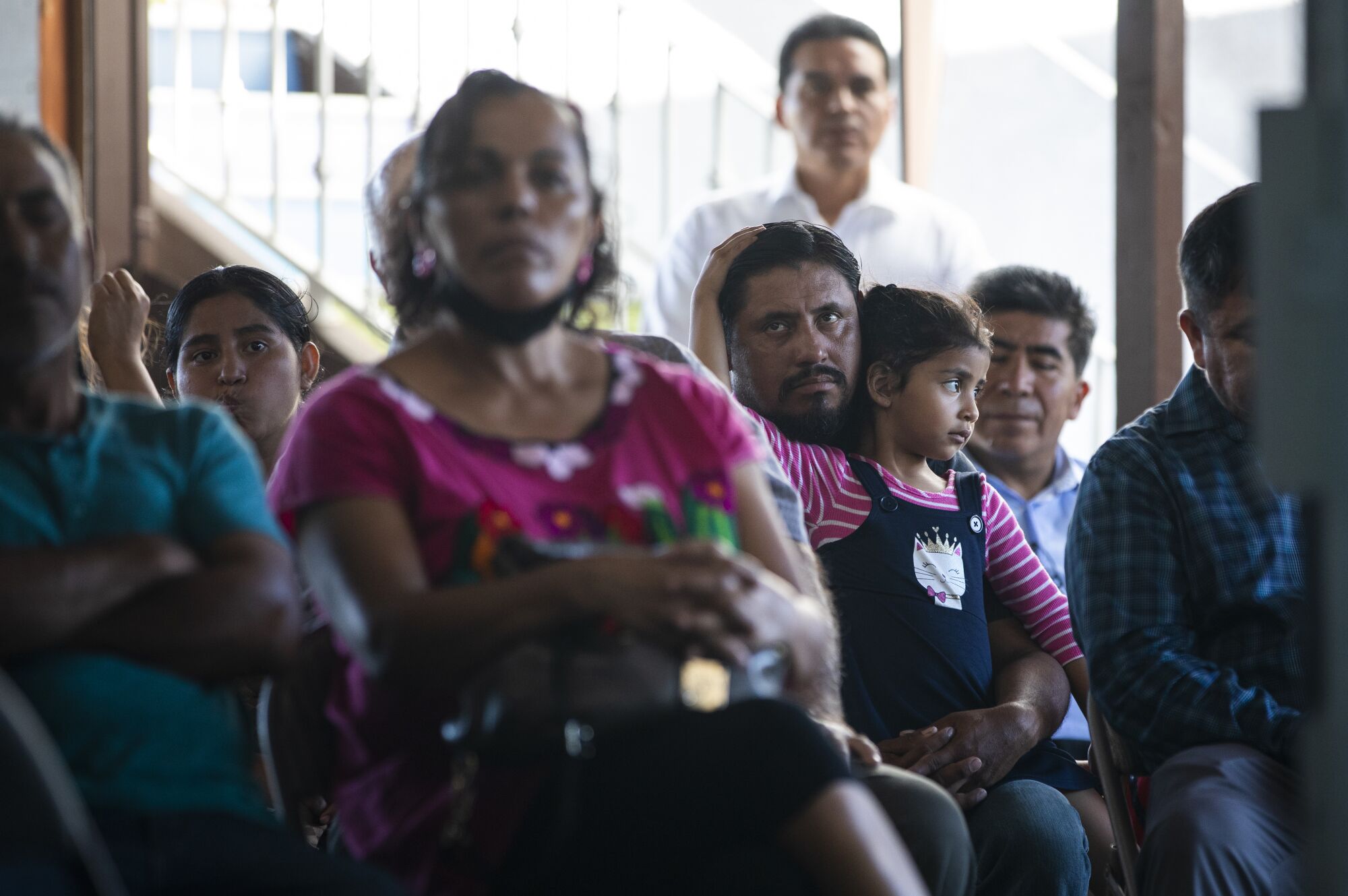 Ronnie Gonzales and his daughter, Rosenda, 5, worship at the Bridge Church in September.