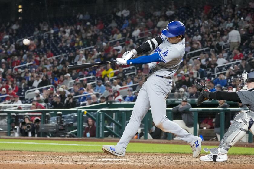 Los Angeles Dodgers designated hitter Shohei Ohtani hits a solo home run during the ninth inning of a baseball game against the Washington Nationals at Nationals Park, Tuesday, April 23, 2024, in Washington. The Dodgers won 4-1. (AP Photo/Alex Brandon)