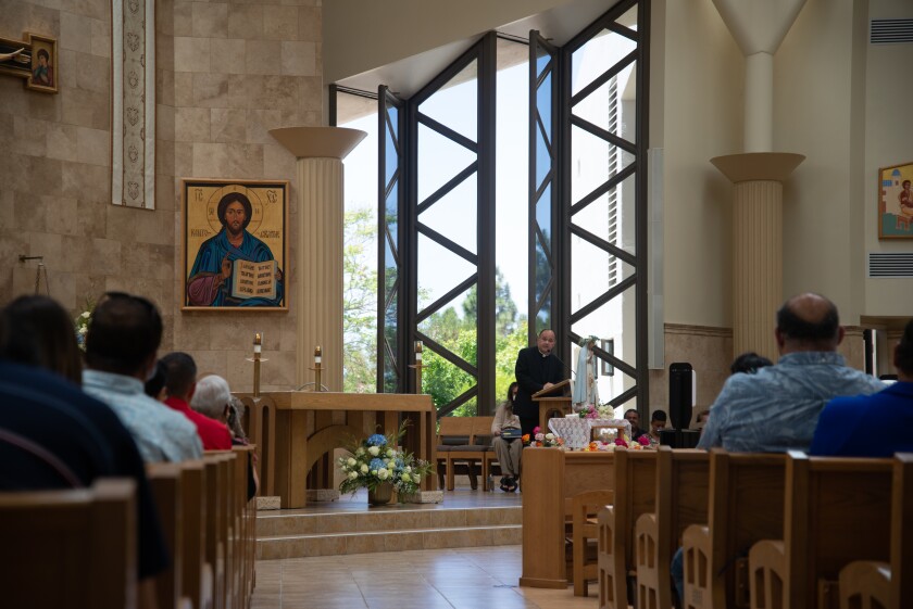 The Rev. Efrain Bautista addresses attendees before the service