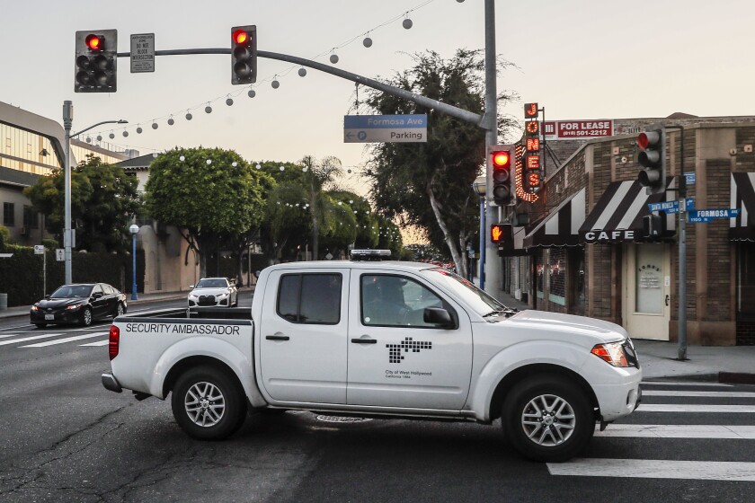 A white pickup truck with "security ambassador" written on the side