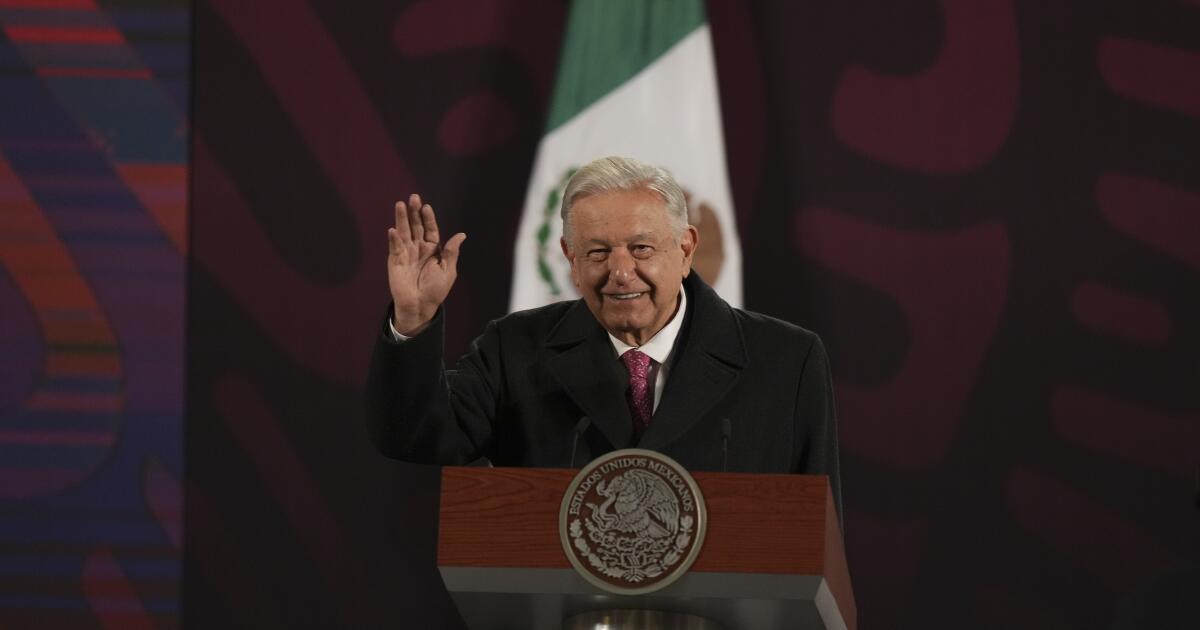 Mexican President Andres Manuel Lopez Obrador waves at the start of his last morning press conference,