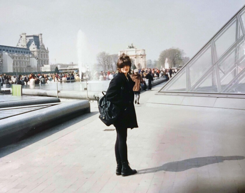A woman standing outside the Louvre