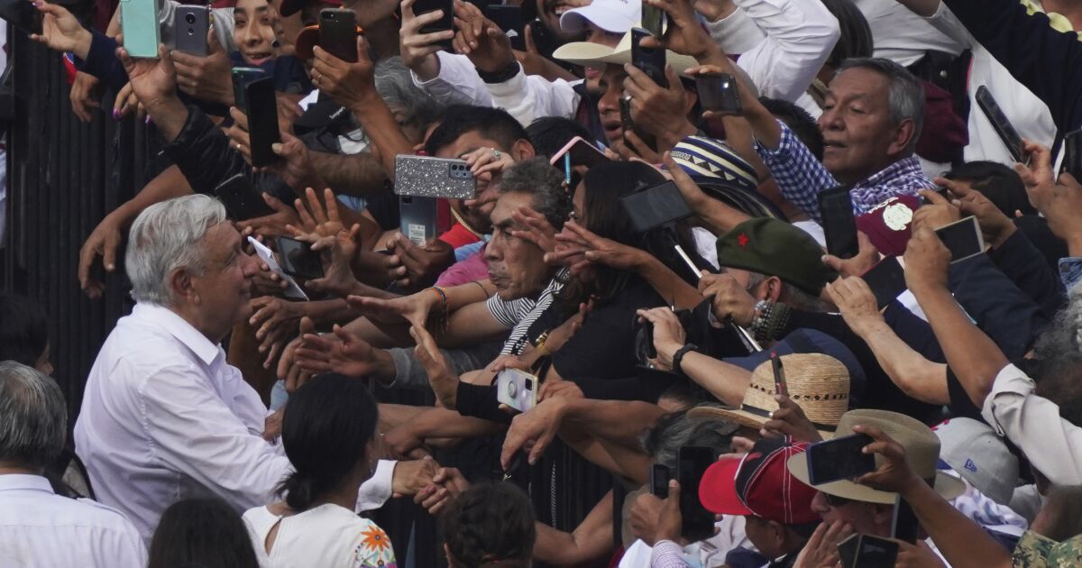 Mexican President Andrés Manuel López Obrador greets supporters as he arrives at the capital's main square, the Zócalo, in Mexico City, Sunday, November 27, 2022. (AP Photo/Marco Ugarte)