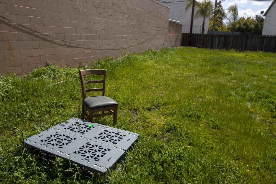 breaking newsFrank Carson Modesto murder plot: the co-defendants 8 A grassy lot with a square, metal covering and a chair.