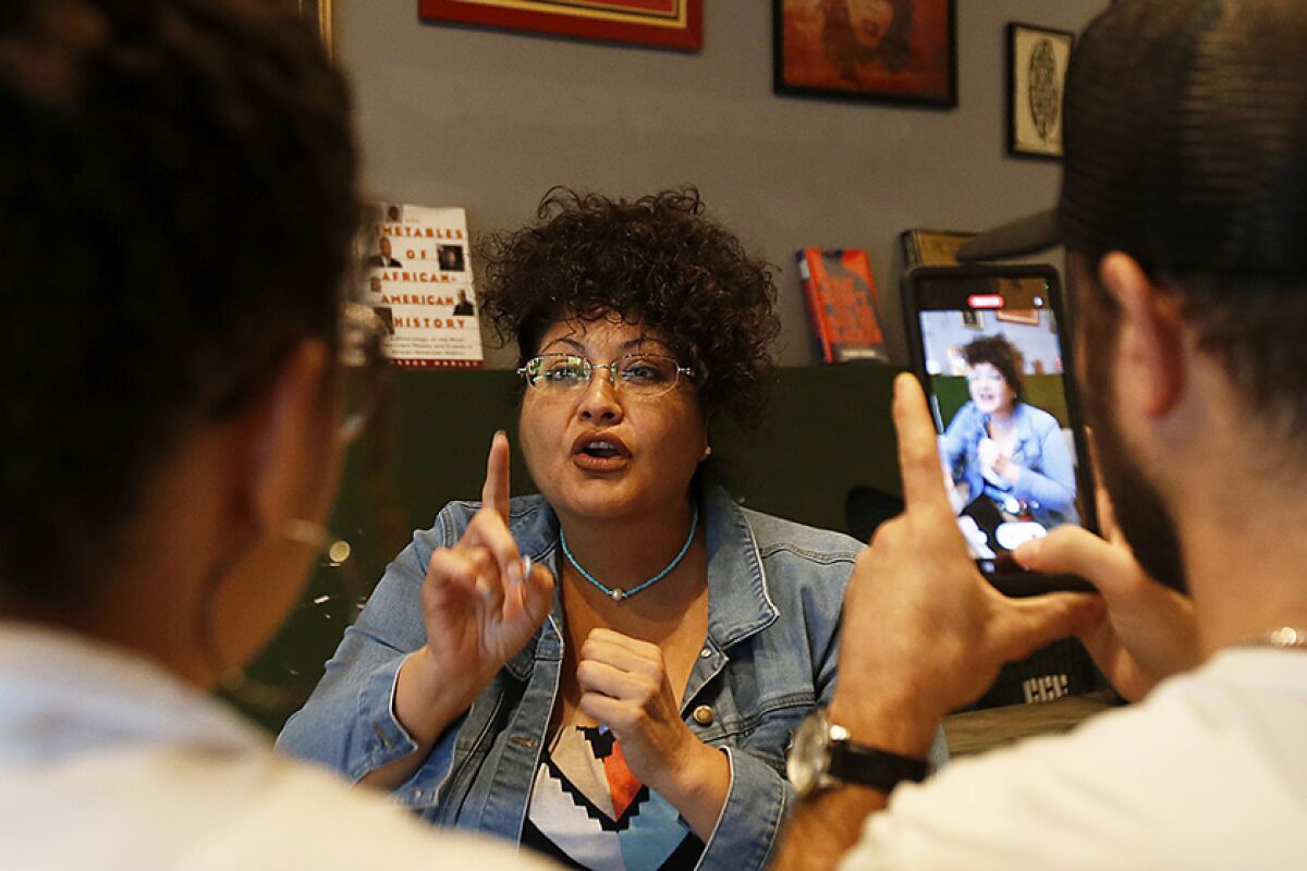 Los Angeles resident Noemi Lujan-Perez talks about a town hall meeting during a watch party in the Crenshaw District.