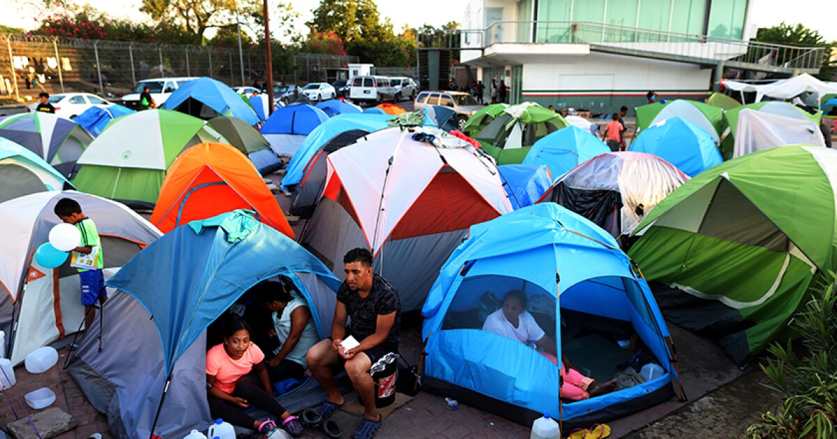 Migrants from Central America and Mexico await the outcome of their U.S. immigration court cases in a tent encampment near the Gateway International Bridge at the U.S.-Mexico border in Matamoros, Tamaulipas, in 2019.
