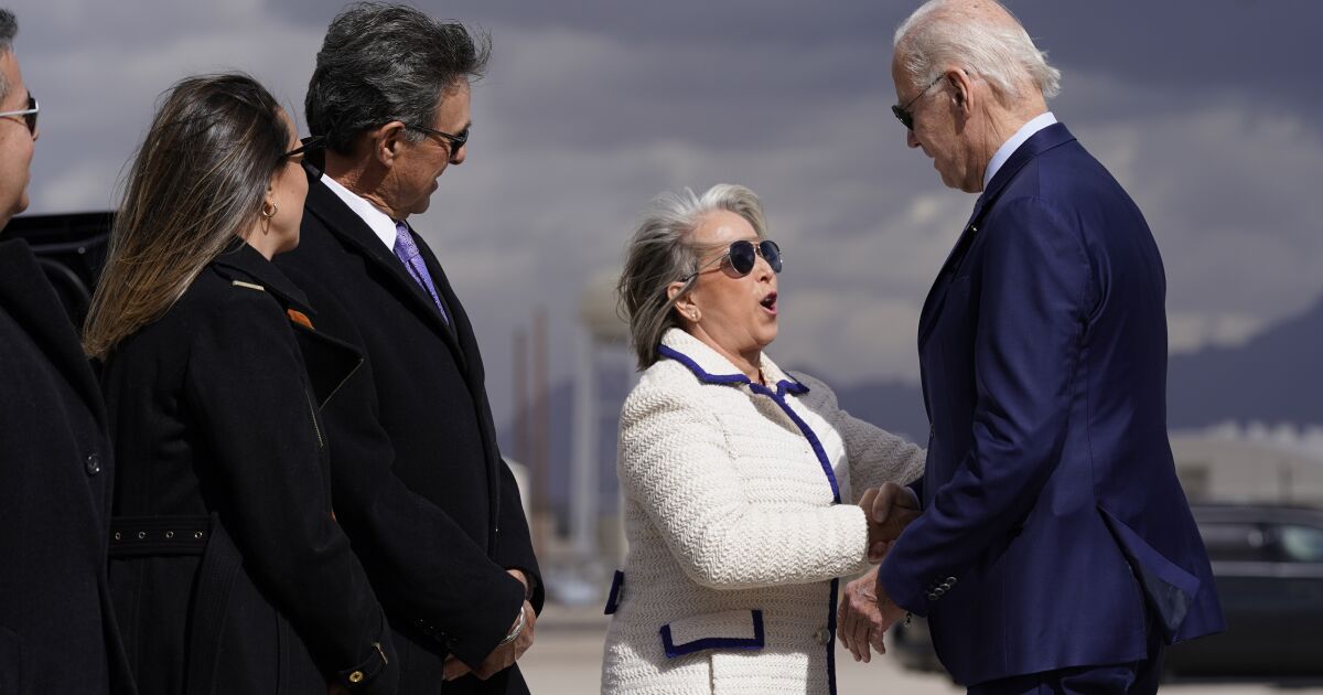 New Mexico Gov. Michelle Lujan Grisham greets President Joe Biden as he arrives at Kirtland Air Force Base in N.M.