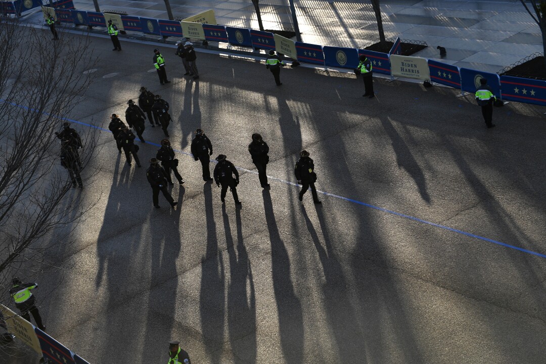 Police officers walk along the inauguration parade route in front of the White House.