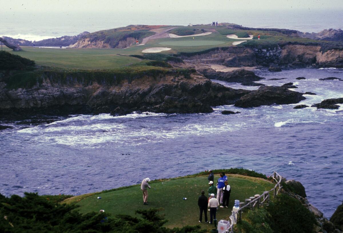 A golfer tees off during the Bing Crosby Pro-Am at Cypress Point Country Club in Monterey.