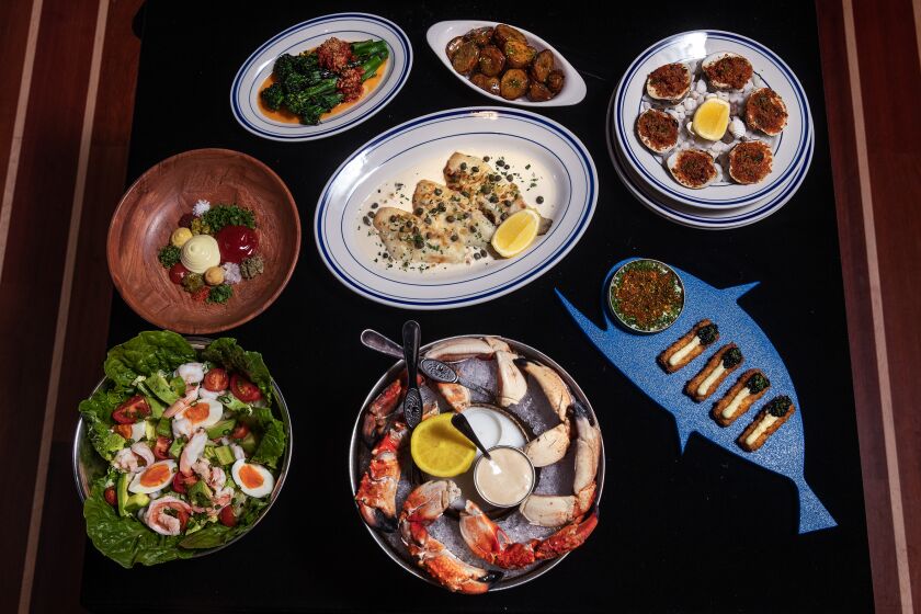 MARINA DEL REY, CA-JANUARY 4, 2023: Clockwise from bottom left-Shrimp Louis, Sand dabs with sides of broccolini and lemony potatoes, Clams Casino, Bougie fish sticks, and Stone crab claws are on the menu at Dear Jane's, a seafood focused restaurant in Marina del Rey. (Mel Melcon / Los Angeles Times)