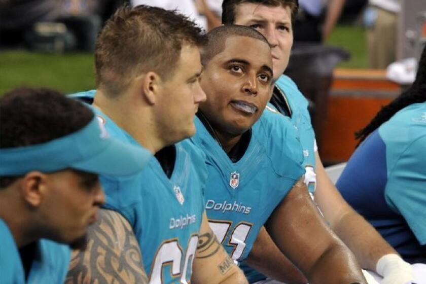 Miami Dolphins guard Richie Incognito (center left) and tackle Jonathan Martin (center right) sit on the bench in the second half of a game against the New Orleans Saints in September. Martin would later go on to accuse Incognito of bullying.
