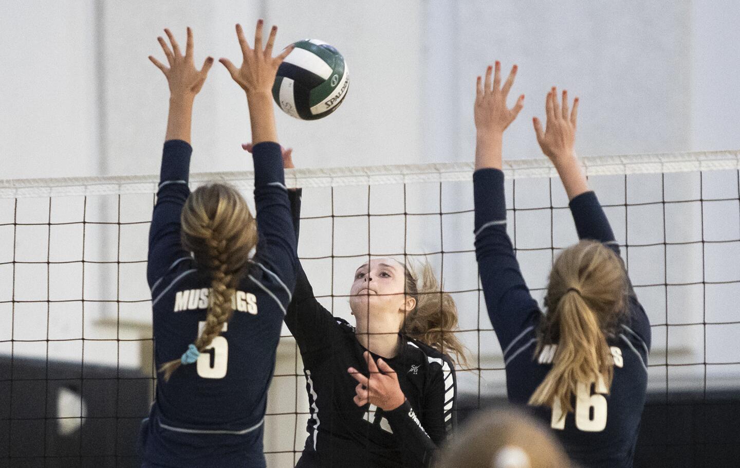 Sage Hill's Danielle Beder hits against Trabuco Hills' Kendall Anselmo, left, and Shannon Spencer during a nonleague match on Tuesday, August 28.