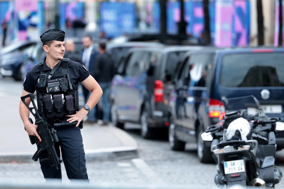 A police offer patrols on a street in Paris three days ahead of the official start of the Paris Olympic Games.