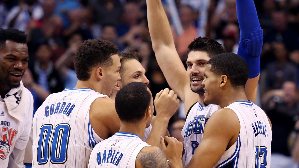 Magic center Nikola Vucevic (arms raised) celebrates with teammates after hitting a game-winning shot at the buzzer against the Lakers.