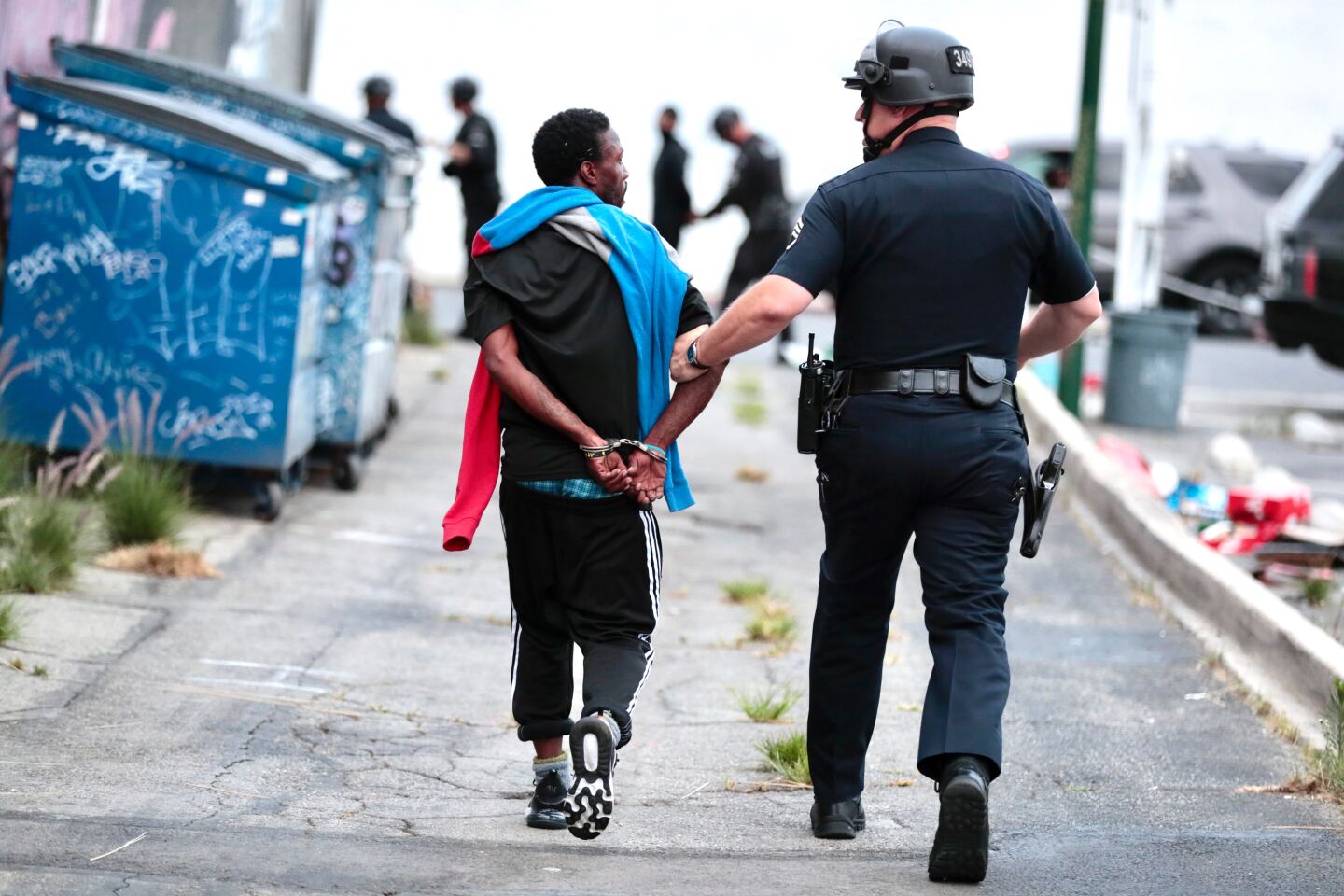 An LAPD officer arrests a looting suspect in an alley behind a Hollywood Boulevard store.
