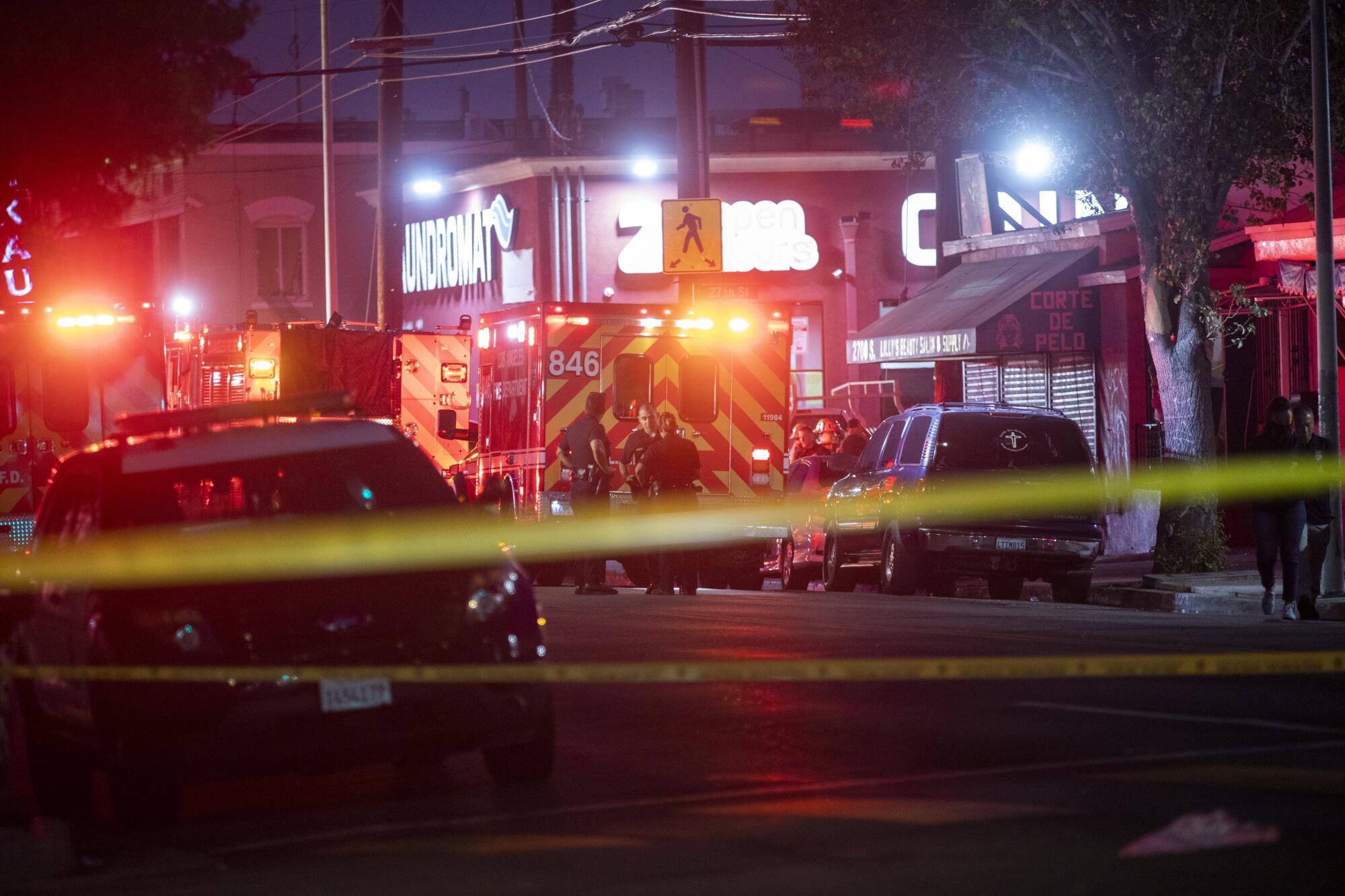 Fire department and police vehicles on a street at night.