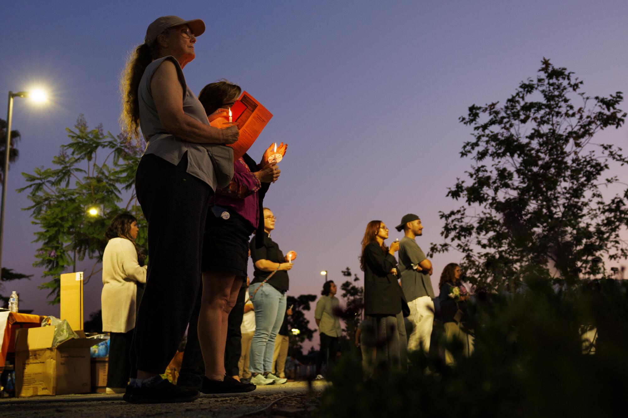 Community members gather for a vigil against the ICE raids in the San Gabriel Valley at Zocalo Park in Baldwin Park.