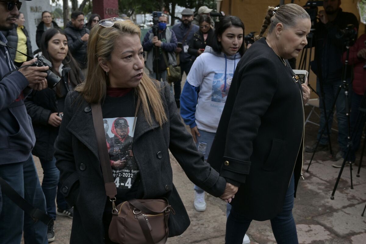 María Elena Frausto, left, Martínez's widow, walks alongside her family.