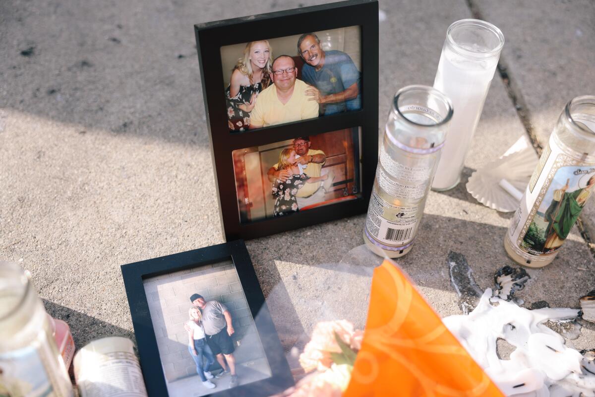 A memorial is seen outside a home where the deaths of three people were found Friday 