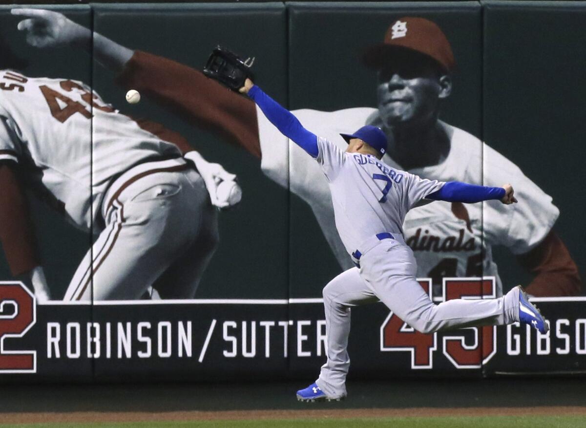 Dodgers left fielder Alex Guerrero is unable to track down a deep drive by St. Louis' Randal Grichuk in the third inning. Grichuk ended up with a run-scoring double.