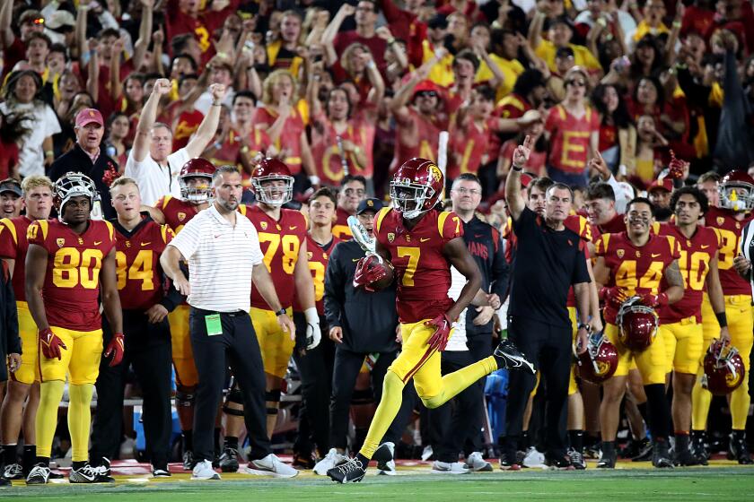 LOS ANGELES, CALIF. - OCT. 1, 2022. USC strong safety Calen Bullock returns an interception against Arizona State in the fourth quarter at the Los Angeles Memorial Coliseum on Saturday night, Oct. 1, 2022. (Luis Sinco / Los Angeles Times)