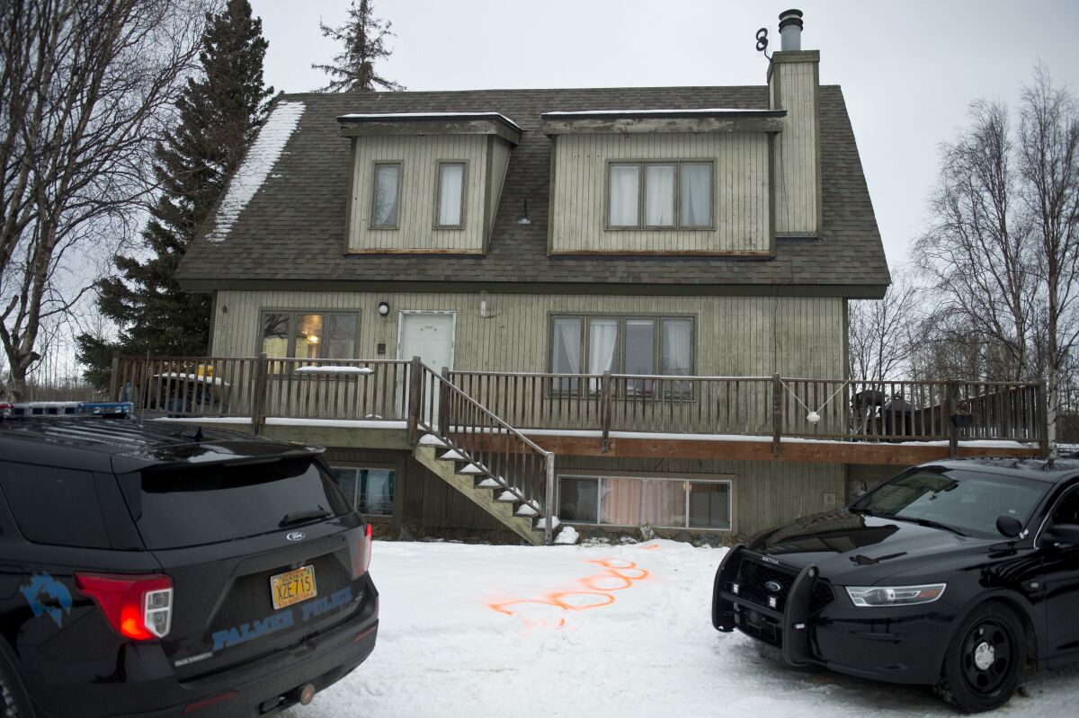 Alaska State Troopers investigate a fatal shooting scene at a home on North Valley Way in Palmer, Alaska, Monday, Nov. 30, 2020. An 18-year-old Alaska man just out of jail for assaulting a family member has been charged with killing four members of his family, including two cousins under the age of 10, charging documents released Tuesday, Dec. 1, 2020 said. (Marc Lester/Anchorage Daily News via AP)