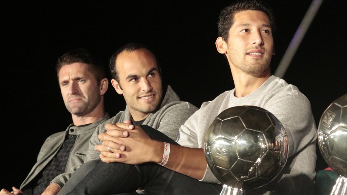 Galaxy teammates (from left) Robbie Keane, Landon Donovan and Omar Gonzalez take part in the team's MLS championship celebration in Hermosa Beach on Monday.