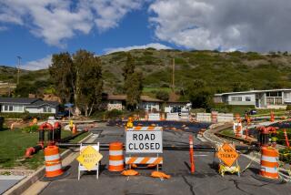 Rancho Palos Verdes, CA - February 09: The road is closed to traffic on Exultant Dr. where land movement exacerbated by recent storms has caused large cracks in pavement and damage to nearby homes in the 4300 block of Dauntless Dr. on Friday, Feb. 9, 2024 in Rancho Palos Verdes, CA. (Brian van der Brug / Los Angeles Times)