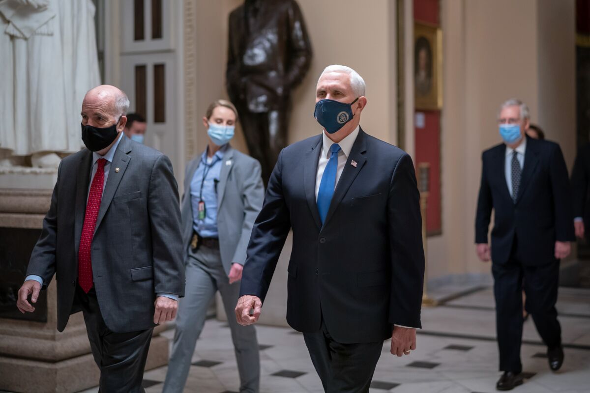 Vice President Mike Pence returns to the House chamber just before midnight on Jan. 6, 2021.