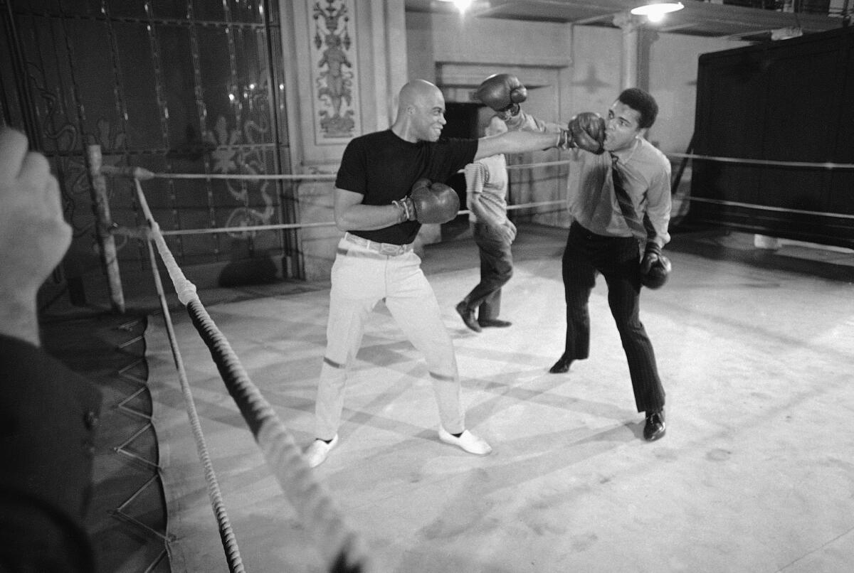 Muhammad Ali, right, gets hit by a left-handed punch from actor James Earl Jones.