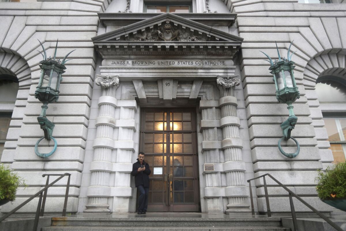 A man stands outside the 9th U.S. Circuit Court of Appeals building in San Francisco.