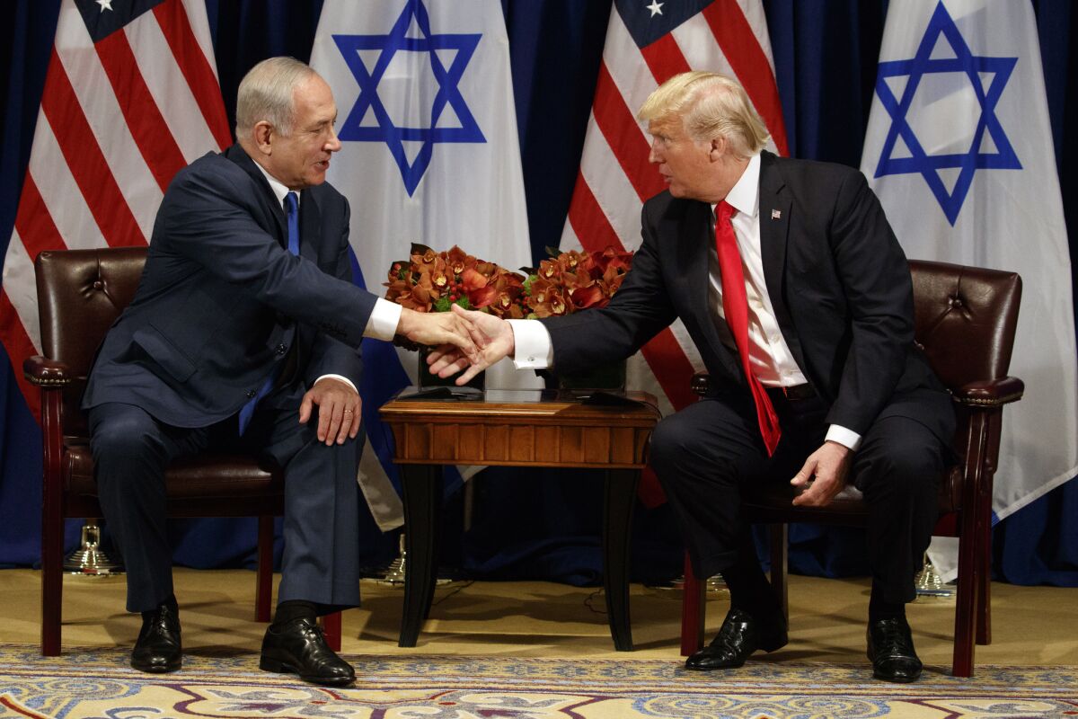 President Trump shakes hands with Israeli Prime Minister Benjamin Netanyahu during a meeting at the Palace Hotel during the United Nations General Assembly.