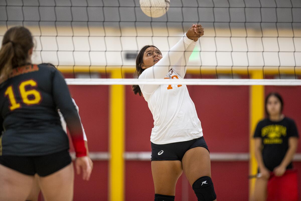 Los Amigos' Alihza Montillo passes a ball during a volleyball match against Estancia on Thursday.