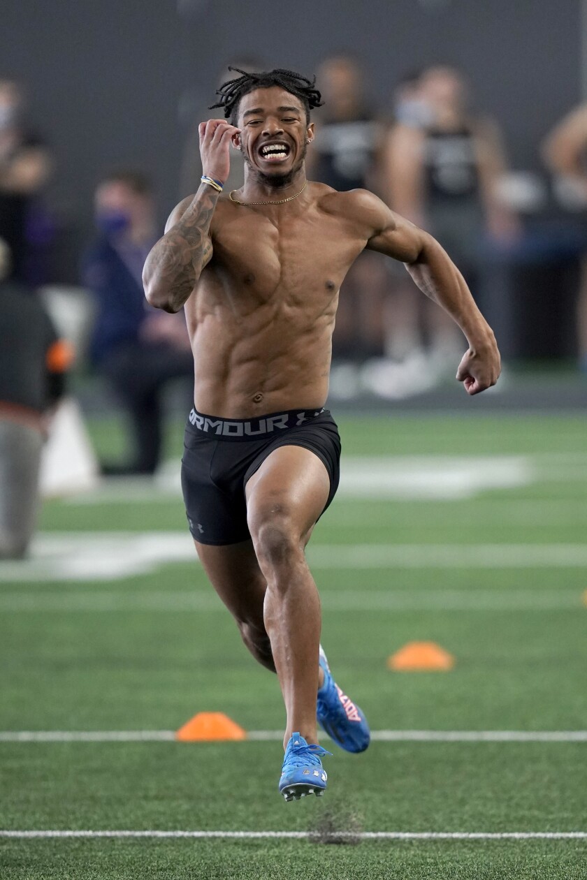 Northwestern cornerback Greg Newsome II, runs in the 40 yard-dash during the school's Pro Day football workout for NFL scouts Tuesday, March 9, 2021, in Evanston, Ill. (AP Photo/Charles Rex Arbogast)