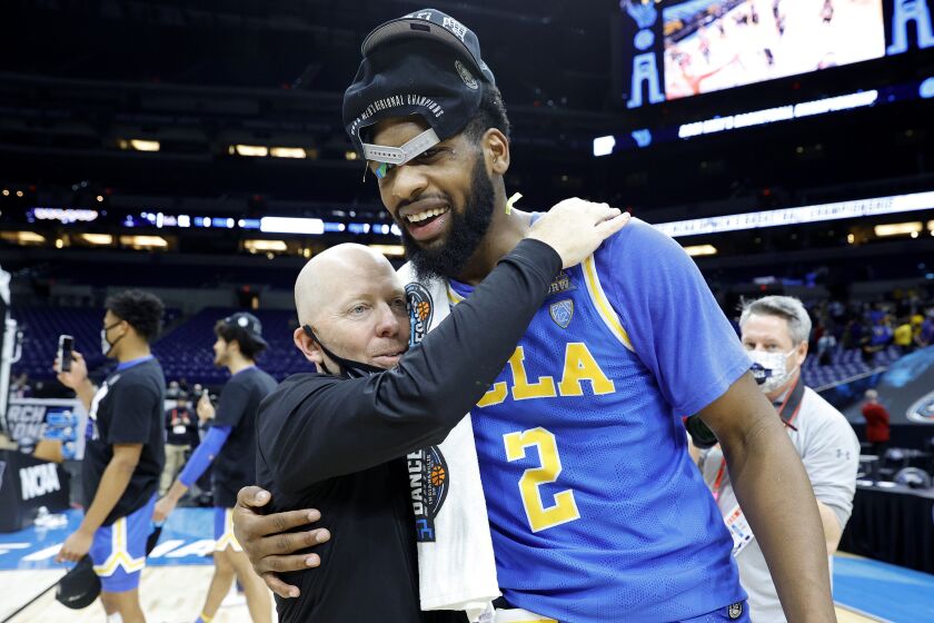 INDIANAPOLIS, INDIANA - MARCH 30: Head coach Mick Cronin of the UCLA Bruins celebrates with Cody Riley #2 after defeating the Michigan Wolverines 51-49 in the Elite Eight round game of the 2021 NCAA Men's Basketball Tournament at Lucas Oil Stadium on March 30, 2021 in Indianapolis, Indiana. (Photo by Tim Nwachukwu/Getty Images)