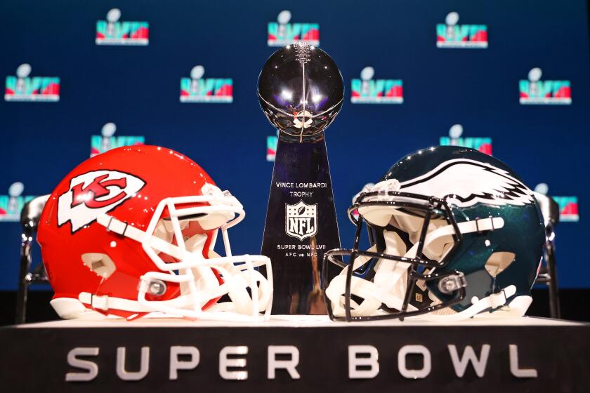 A view of the Vince Lombardi Trophy and the helmets of the Kansas City Chiefs and the Philadelphia Eagles.