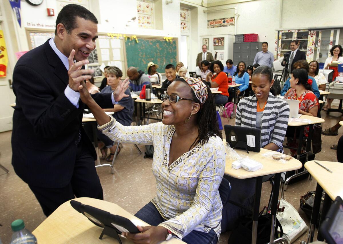 Jaime Aquino, left, then-deputy superintendent of L.A. Unified School District, with a teacher at an iPad training session in 2013.