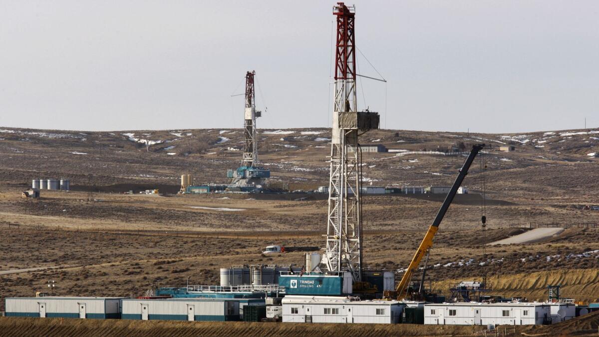 Drilling rigs are seen off of Way Highway 59 outside of Douglas, Wyo. on March 5, 2013.