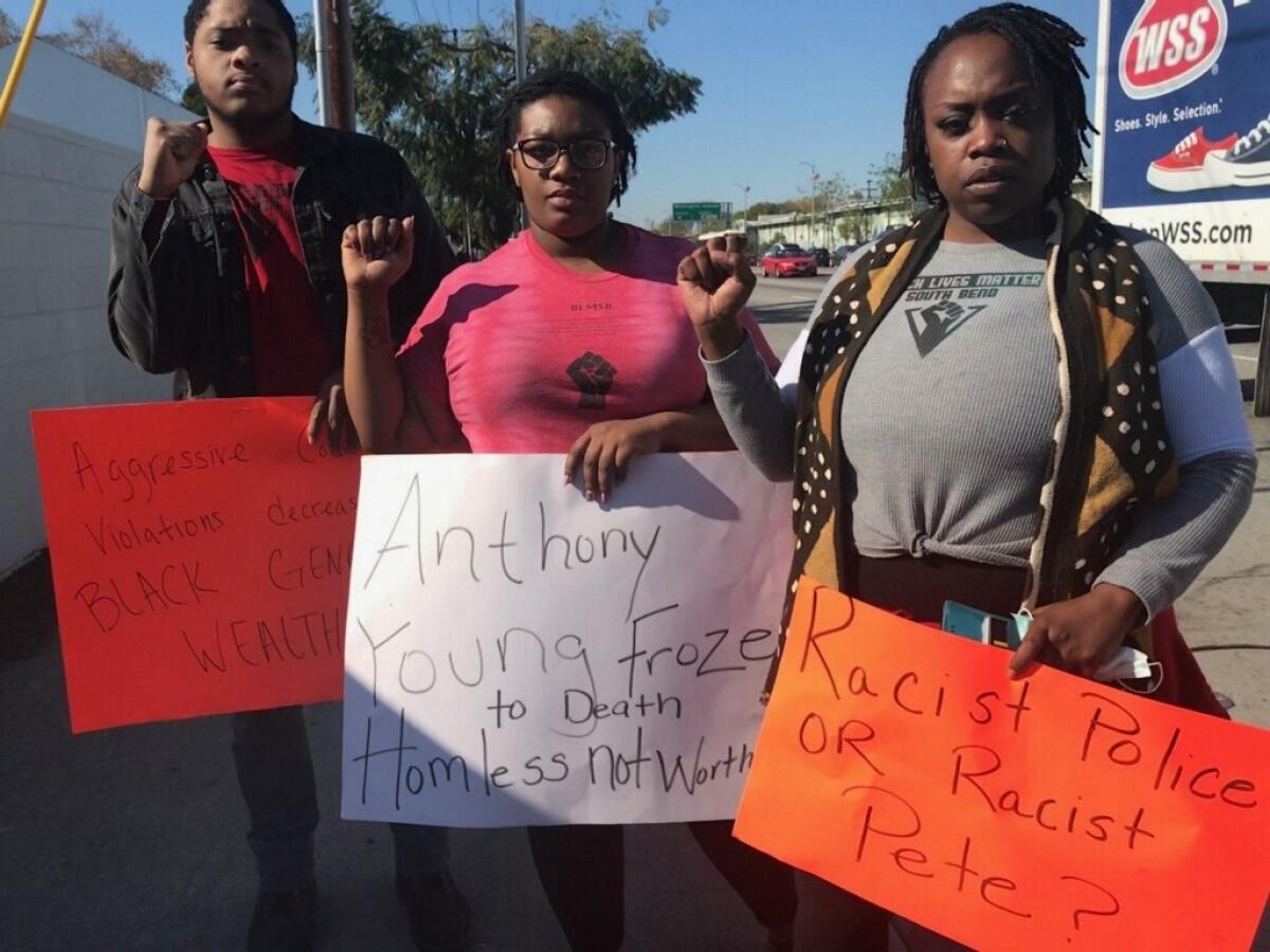 Black Lives Matter protesters Anthony Thomson, left, Kahmiil Middleton and Katheryn Redding traveled from South Bend, Ind., to protest Pete Buttigieg in Los Angeles.