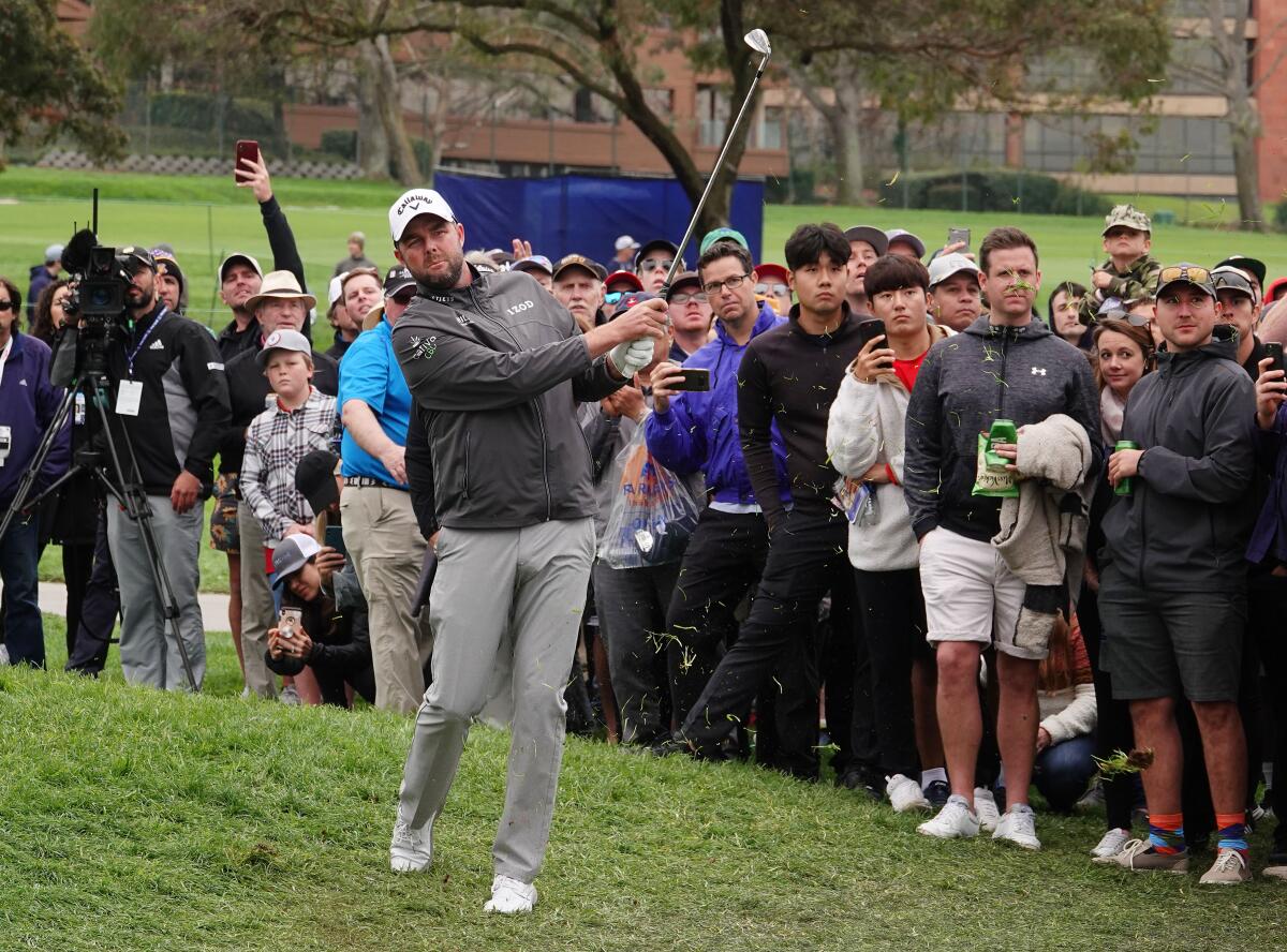 Marc Leishman hits from the rough on the 14th hole during the Farmers Insurance Open at Torrey Pines Golf Course.