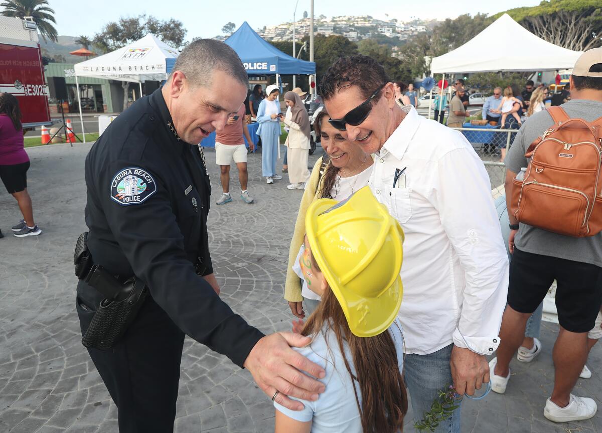 Police Chief Jeff Calvert chats with guests during National Night Out activities at Main Beach Park in Laguna Beach.