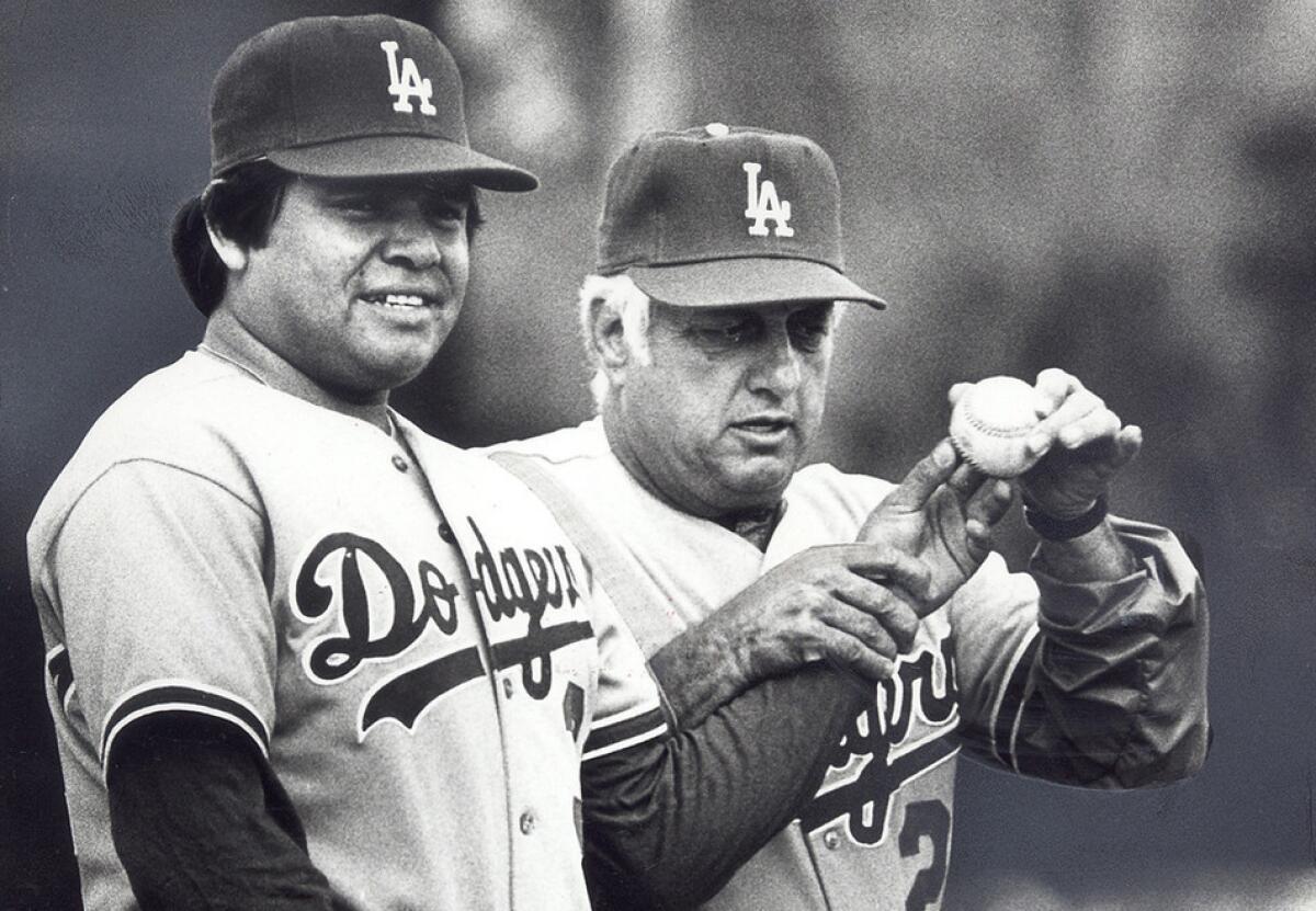 Dodgers manager Tommy Lasorda checks the grip of pitcher Fernando Valenzuela during a spring training workout in 1983.