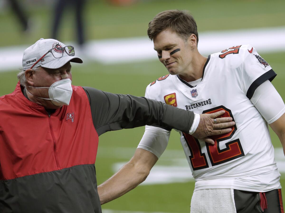 Tampa Bay Buccaneers coach Bruce Arians, left, speaks with quarterback Tom Brady.