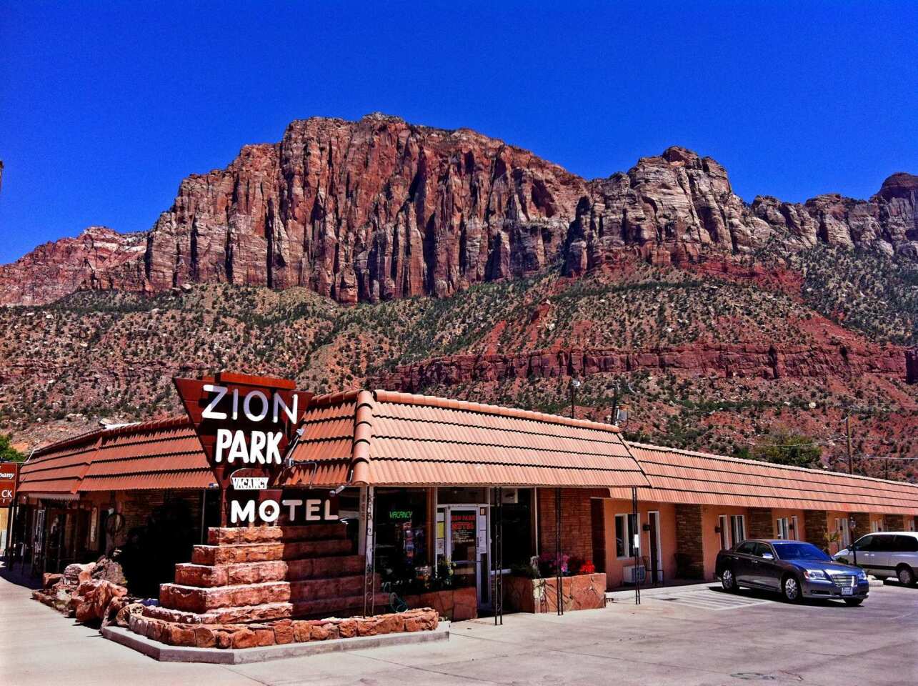 Towering red sandstone cliffs surround the low-slung Zion Park Motel in Springdale, Utah, built in 1972 and just a mile from the national park.