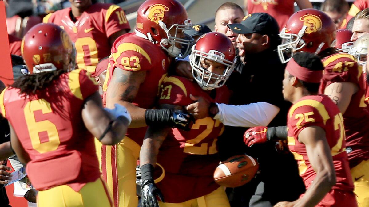 USC safety Gerald Bowman celebrates with teammates and team staff after intercepting a pass in the second quarter of Saturday's game against Notre Dame.