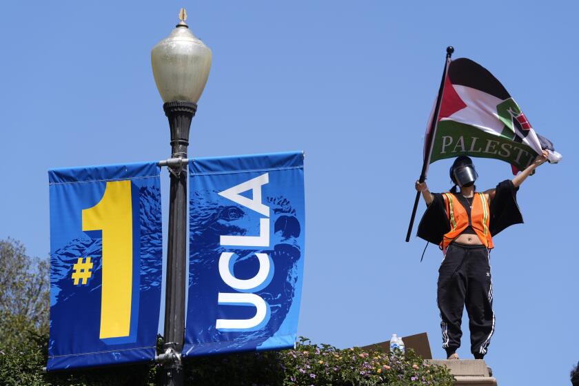 FILE - Demonstrators wave flags on the UCLA campus, after nighttime clashes between Pro-Israel and Pro-Palestinian groups, May 1, 2024, in Los Angeles. If the University of California, one of the largest public university systems in the country, were to agree to divestment calls from students protesting the Israel-Hamas war, the system would lose $32 billion of its overall $175 billion in assets, officials said on Tuesday, May 15, 2024. (AP Photo/Jae C. Hong, File)