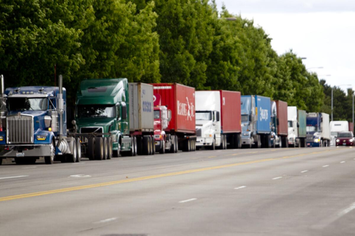 Tractor trailer trucks back up at the Port of Portland on June 18, 2012, while members of the West Coast longshore union use slowdown tactics at the container terminal.
