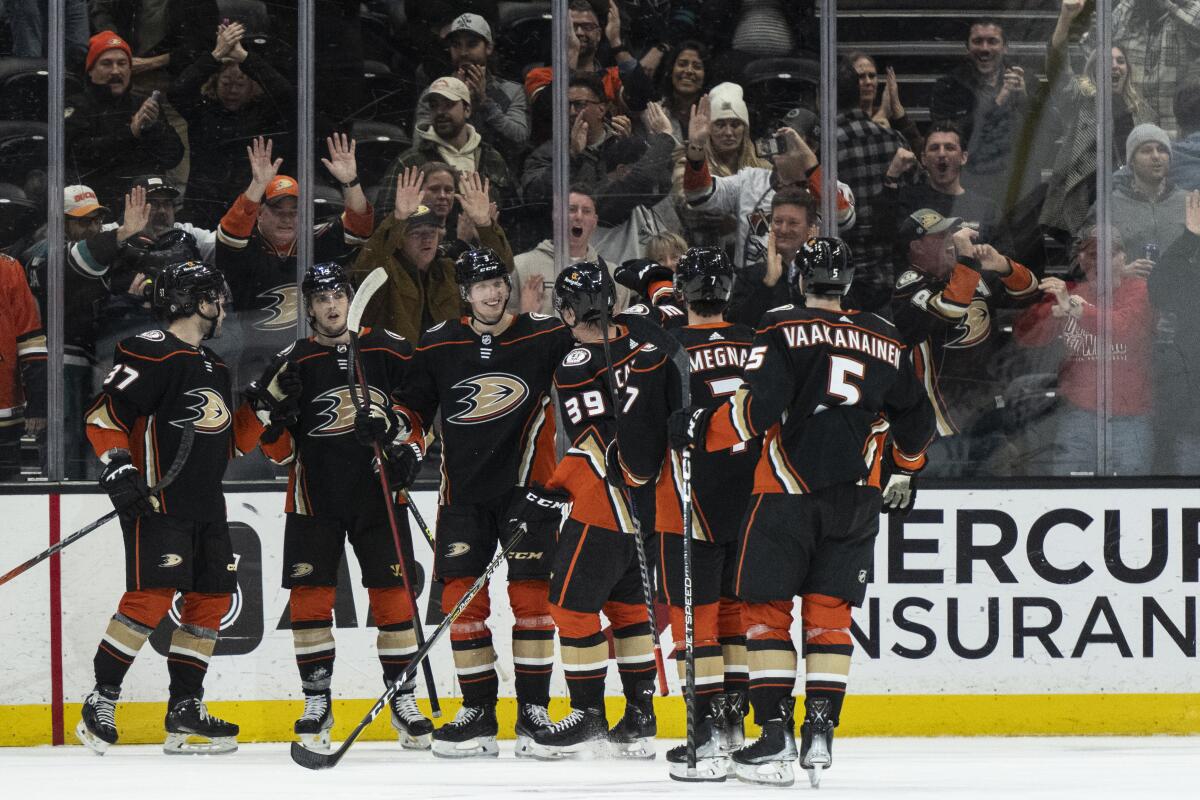 The Ducks celebrate a 5-4 overtime win over the San Jose Sharks.